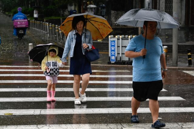 Hundreds of millions of people in northern China, including Beijing, remain under a red al