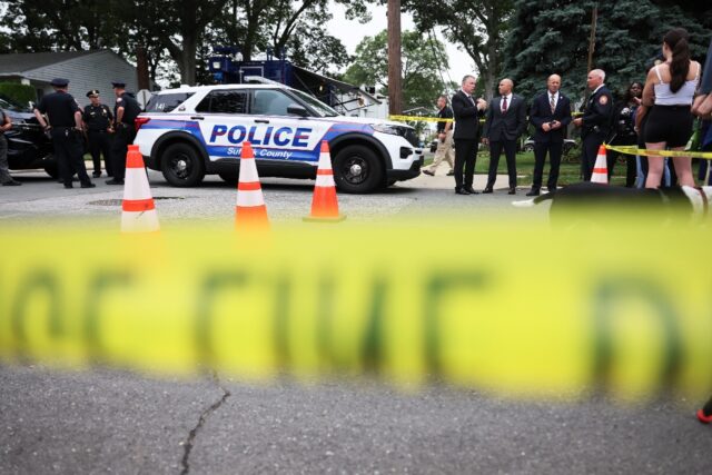 Law enforcement officials outside the home in Massapequa Park, New York, of a suspect arre