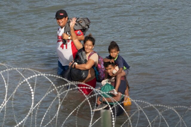 Migrants crossing the Rio Grande river near Eagle Pass, Texas, hoping to enter the United