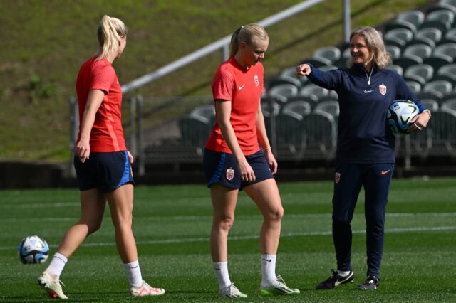 Norway head coach Hege Riise (R) passes on instructions to her players at a training sessi
