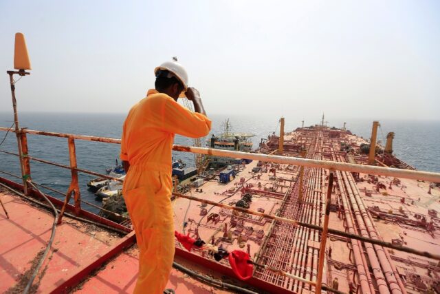 A man stands on the deck of the beleaguered FSO Safer oil tanker, in the Red Sea off the c