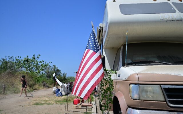 A US flag is displayed on a recreational vehicle parked along Jefferson Boulevard in Los