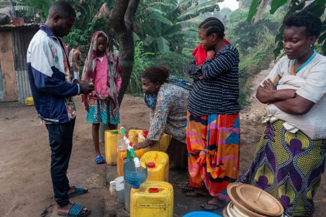A woman fills a jerrycan with water in Selembao, a poor neighbourhood with very little wat