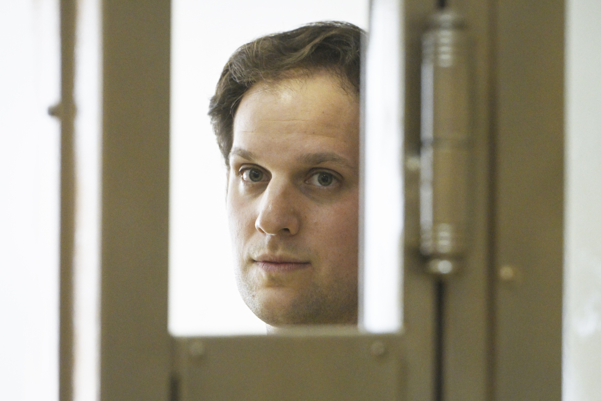 Wall Street Journal reporter Evan Gershkovich stands in a glass cage in a courtroom at the Moscow City Court in Moscow, Russia, June 22, 2023. (AP Photo/Dmitry Serebryakov, File)