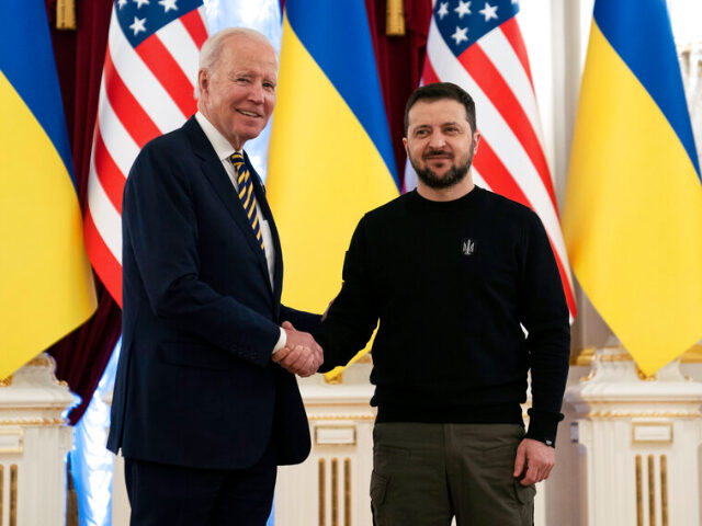 US President Joe Biden, left, shakes hands with Ukrainian President Volodymyr Zelenskyy at