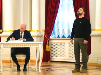 US President Joe Biden signs a guest book during his meeting with Ukrainian President Volo
