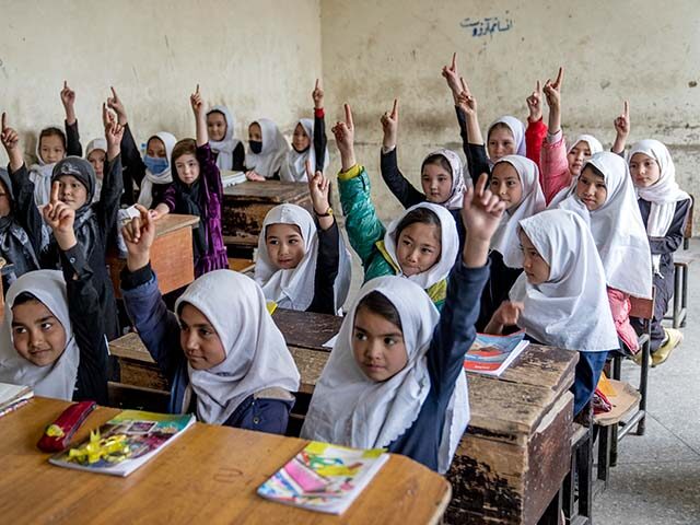 Afghan school girls attend their classroom on the first day of the new school year, in Kab
