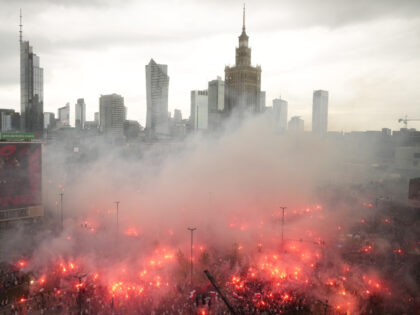 People light flares in Poland's capital as the country marks the 79th anniversary of