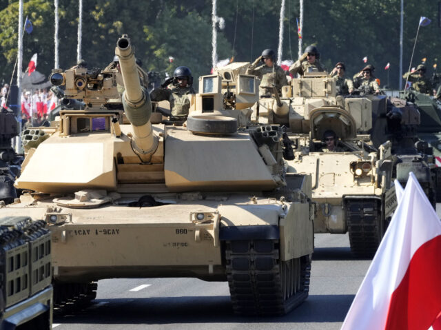 U.S.-made Abrams tanks purchased by Poland take part in a massive military parade to celeb