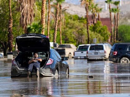 Dorian Padilla sits in his car as he waits for a tow after it got stuck in the mud on a street Monday, Aug. 21, 2023, in Cathedral City, Calif. Forecasters said Tropical Storm Hilary was the first tropical storm to hit Southern California in 84 years, bringing the potential …