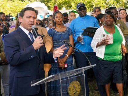 Florida Gov. Ron DeSantis, left, speaks at a prayer vigil for the victims of a mass shooting a day earlier, in Jacksonville, Fla., Sunday, Aug. 27, 2023. (AP Photo/John Raoux)