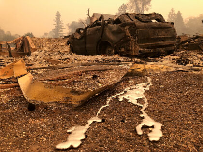 A burned out car sits on the side of the road in Paradise, Calif., Friday, Nov. 9, 2018, a
