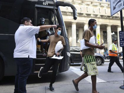 Migrants are led from one bus to another after arriving from Texas at Union Station on Sept. 9, 2022, in Chicago. (Chris Sweda/Chicago Tribune/Tribune News Service via Getty Images)