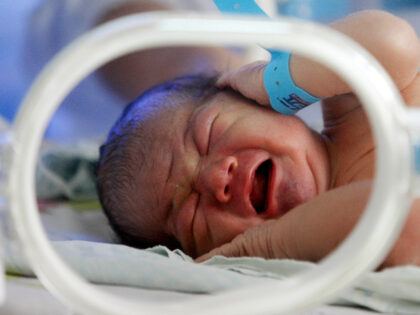 A new baby is laying on a bed in a hosiptal in Huaibei, Anhui province, China on 12th Nove