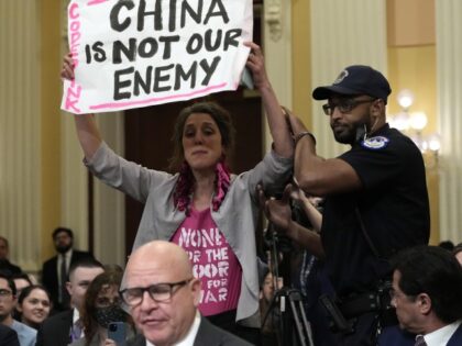 A protester interrupts H.R. McMaster, former national security adviser to President Donald Trump, as he testifies during a hearing of a special House committee dedicated to countering China, on Capitol Hill, Tuesday, Feb. 28, 2023, in Washington. (AP Photo/Alex Brandon)