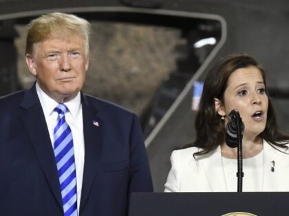 In this Aug. 13, 2018 file photo, President Donald Trump, left, listens as Rep. Elise Stefanik, R-N.Y., speaks before signing a $716 billion defense policy bill named for John McCain at Fort Drum, N.Y. In two New York congressional districts just miles apart, Republican incumbents facing re-election battles are waging …