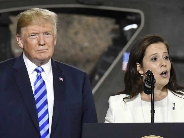 In this Aug. 13, 2018 file photo, President Donald Trump, left, listens as Rep. Elise Stef