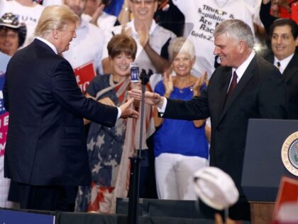 Franklin Graham (R), son of evangelist Billy Graham, is greeted by U.S. President Donald T