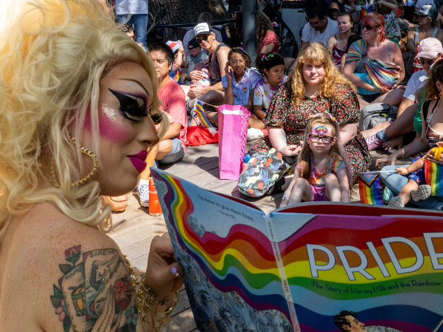 AUSTIN, TEXAS - JUNE 10: Austin, Tx drag queen Brigitte Bandit reads a book during a drag