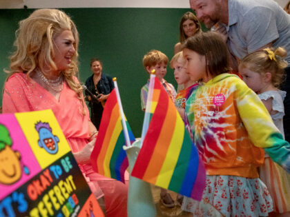 LAGUNA BEACH, CA - JUNE 17: Drag Queen Pickle, left, reads a story to children during Drag