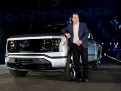Jim Farley, Ford Motor Company's chief executive officer, stands next to the company's new