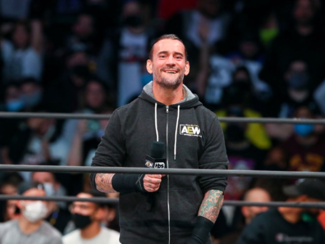 AEW star CM Punk poses with 'trans rights are human rights' sign