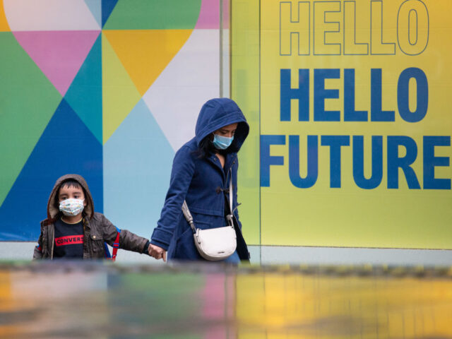 A mother and son in face masks in the rain on Market Street during a third national lockdown on Thursday 14th January 2021. (Photo by Pat Scaasi/MI News/NurPhoto via Getty Images)