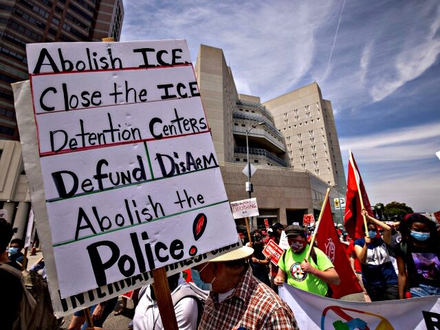 People protesting ICE (US Immigration and Customs Enforcement) detention centers pass The