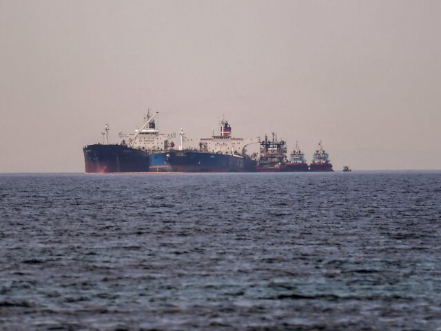 The Liberian-flagged oil tanker Ice Energy (L) transfers crude oil from the Russian-flagge