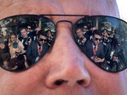 Reporters are reflected in the sunglasses of U.S. President Joe Biden as he speaks to the press before boarding Marine One on the South Lawn of the White House October 6, 2022 in Washington, DC. President Biden is traveling to Poughkeepsie, New York to tour an IBM facility. The company …
