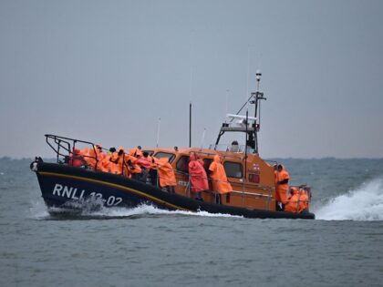 Migrants, picked up at sea attempting to cross the English Channel from France, are brought ashore on a Royal National Lifeboat Institution (RNLI) lifeboat at Dungeness on the southeast coast of England, on December 9, 2022. (Photo by Ben Stansall / AFP) (Photo by BEN STANSALL/AFP via Getty Images)