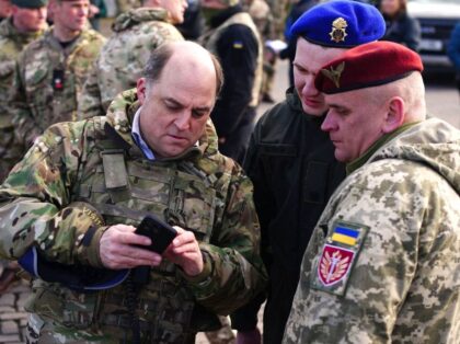 Britain's Defence Secretary Ben Wallace (L) meets with Ukrainian solders who are trai