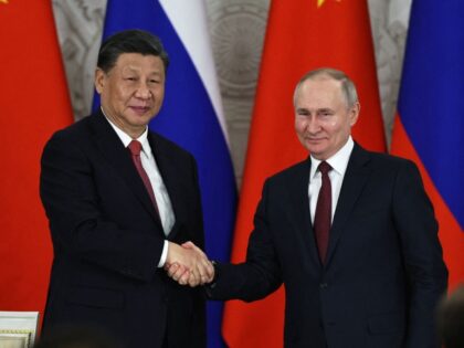 Russian President Vladimir Putin and China's President Xi Jinping shake hands after delivering a joint statement following their talks at the Kremlin in Moscow on March 21, 2023. (Photo by Mikhail TERESHCHENKO / SPUTNIK / AFP) (Photo by MIKHAIL TERESHCHENKO/SPUTNIK/AFP via Getty Images)