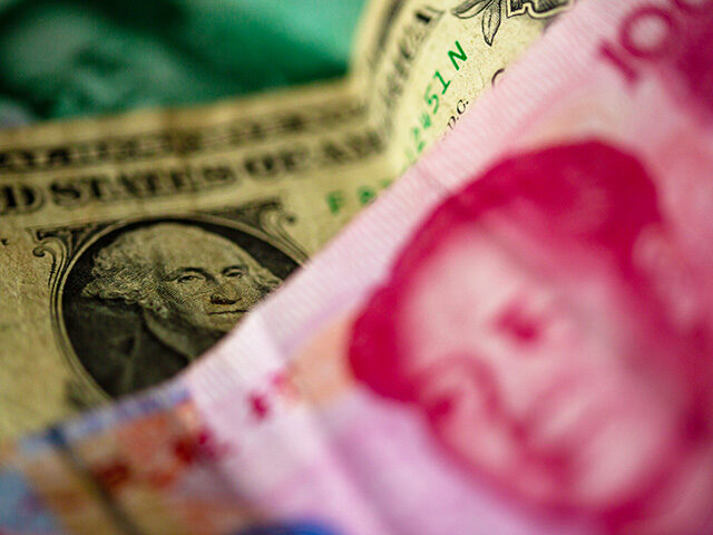 27 April 2023, Berlin: A Chinese 100 yuan banknote (front) and a 1 US dollar bill (M) are