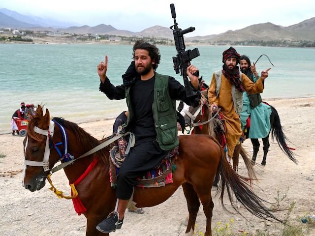 TOPSHOT - Taliban security forces ride horses along the Qargha Lake on the outskirts of Ka