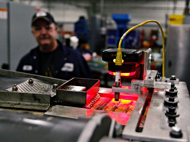 Mike Cira watches over an automated machine at a Master Lock manufacturing plant in Milwaukee, Wis., Tuesday, Jan. 10, 2012. Photographer: Andy Manis/Bloomberg News
