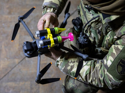 A drone operator with the Ukrainian Army's 93rd Brigade attaches grenades to a DJI Mavic 3 drone on February 18, 2023 in Bakhmut, Ukraine. Ukrainian forces have been using drones for traditional reconnaissance and directing artillery fire but have also modified them to conduct direct attacks on Russian infantry. (Photo …