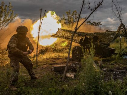 DONETSK OBLAST, UKRAINE - JULY 22: Ukrainian soldier firing artillery in the direction of