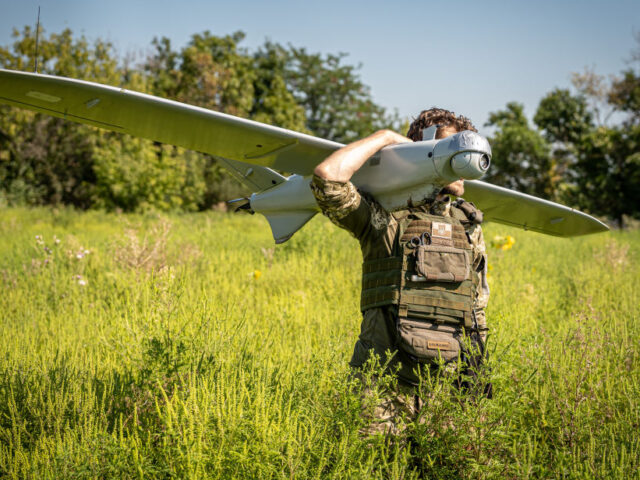DONETSK OBLAST, UKRAINE - AUGUST 5: Ukrainian soldiers carry their surveillance drone to t