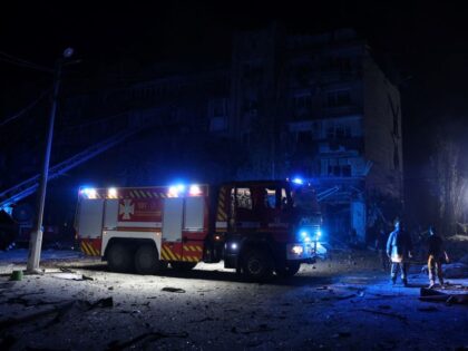 Rescuers are at work near a damaged residential building following Russian missiles strike