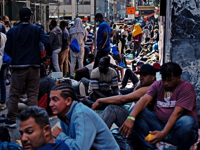NEW YORK, NEW YORK - AUGUST 02: Migrants gather outside of the Roosevelt Hotel where dozen