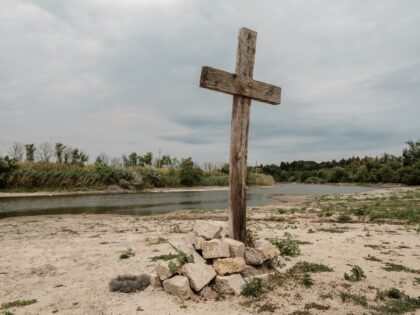 VELYKA OLEKSANDRIVKA, UKRAINE - JULY 13: A wooden cross is installed on the shore of Inhul