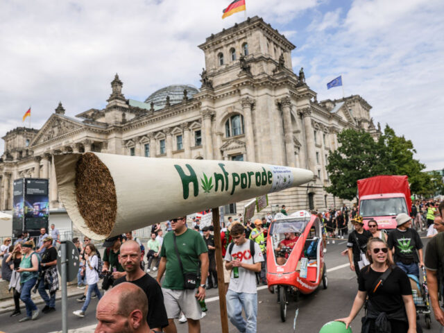 BERLIN, GERMANY - AUGUST 12: Cannabis supporters march with a giant mock joint past the Re
