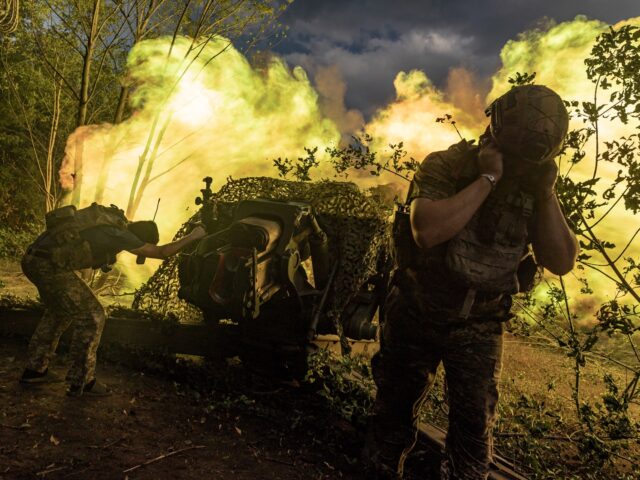 DONETSK OBLAST, UKRAINE - AUGUST 12: Ukrainian soldiers fire the D-30 artillery to Russian