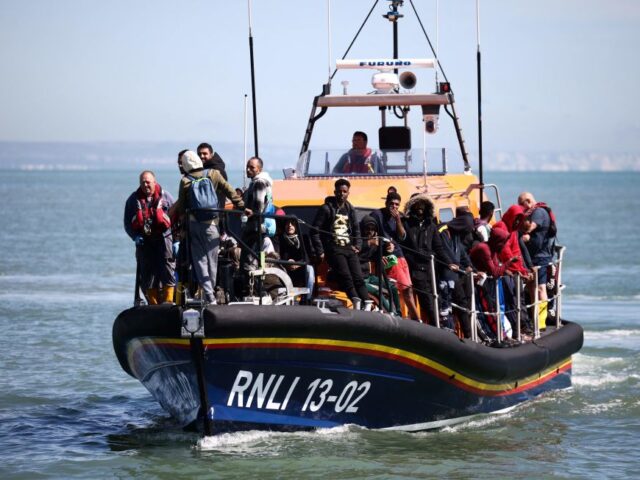 Migrants are pictured aboard of a Royal National Lifeboat Institution (RNLI) lifeboat afte