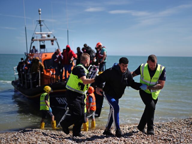 A group of people thought to be migrants are brought in to Dungeness, Kent, onboard an RNL