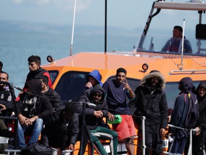 A group of people thought to be migrants are brought in to Dungeness, Kent, onboard an RNL