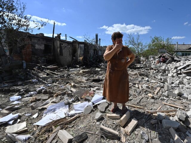 TOPSHOT - Tatyana Skrypnikova, 60, who sustained light shrapnel wounds, stands among debri