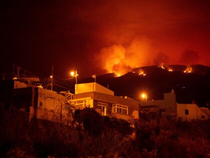 A picture taken in the night of August 19, 2023 shows the fronts of the forest fire on hills above houses, in the Guimar valley on the Canary Island of Tenerife. The blaze, which officials say is the most "complex fire" to hit the Canary Islands in 40 years, broke …