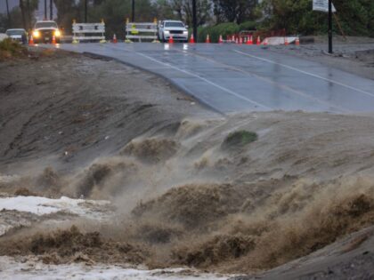 INDIO, CALIFORNIA - AUGUST 20: A usually dry section of the Whitewater River floods a road caused by Tropical Storm Hilary in the deserts of Southern California on August 20, 2023 in Indio, California. More than 40 million people are under the first-ever Tropical Storm Warning issued for the area. …